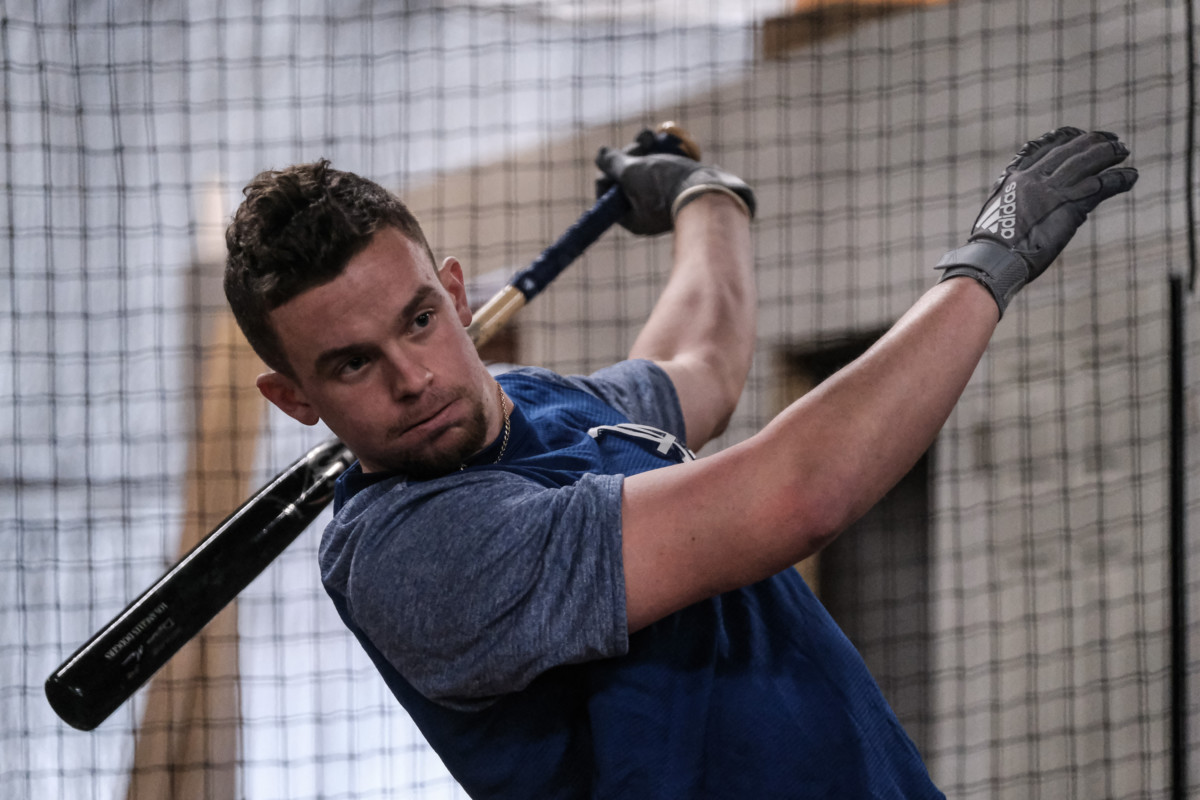 Former Columbus North baseball player Devin Mann relaxes his grip after hitting a ball during batting practice at HIT Baseball in Columbus, Ind., Friday, Jan. 22, 2021. He has been bouncing around the Dodgers' minor league system since being selected by the team in the fifth-round of the 2018 draft. Mike Wolanin | The Republic