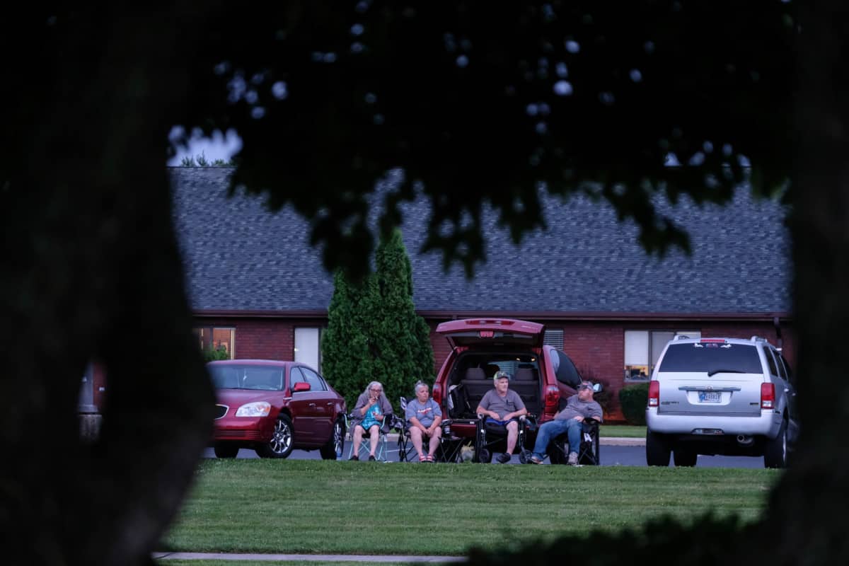 People gather in front of Willow Crossing for the annual QMIX musical fireworks celebration in Columbus, Ind., Wednesday, July 3, 2019. Mike Wolanin | The Republic