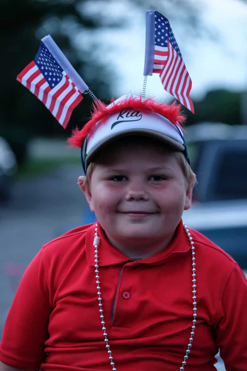 Thomas Sheckles, 7, wears American flags on his head during the annual QMIX musical fireworks celebration in Columbus, Ind., Wednesday, July 3, 2019. Mike Wolanin | The Republic