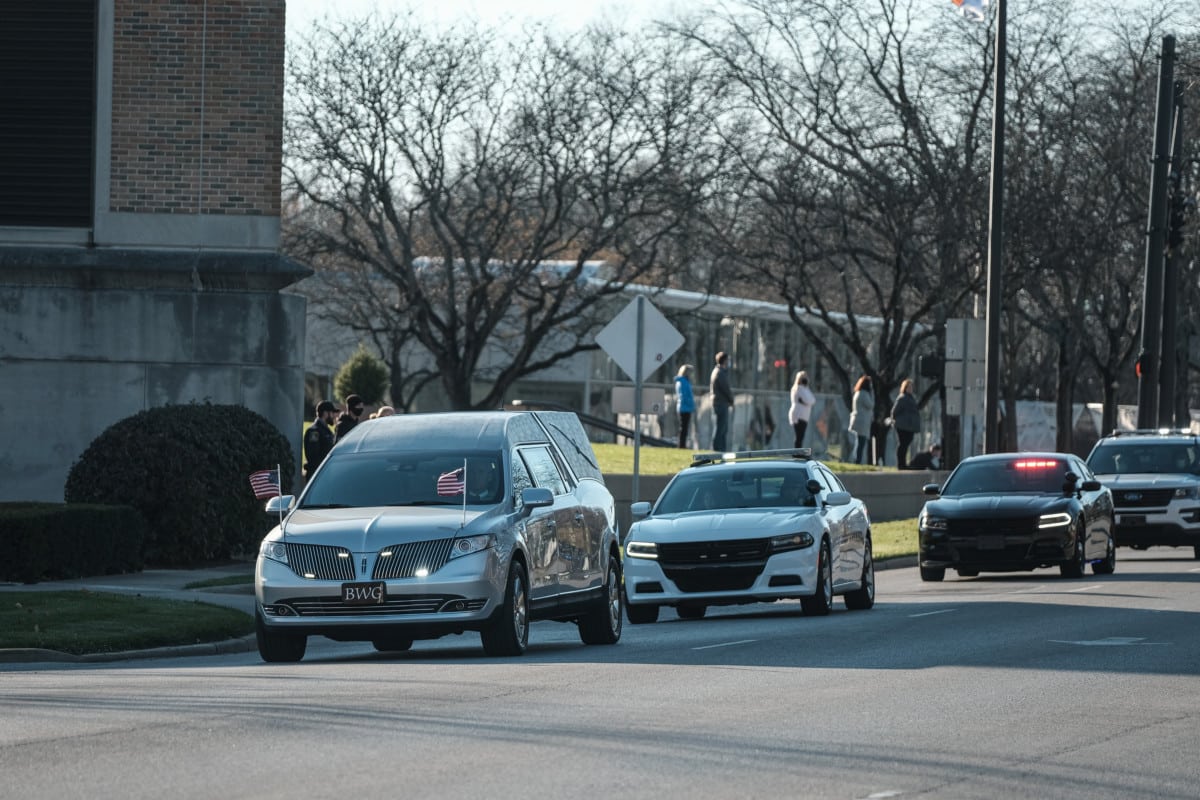 The hearse carrying the body of fallen Bartholomew County Sheriff’s K9 Diesel and a procession of law enforcement vehicles passes by Columbus City Hall in Columbus, Ind., Tuesday, Nov. 17, 2020. Diesel was killed in the line of duty after being stuck by a car while pursing a domestic violence suspect across Interstate 65. Mourners lined up along Second Street to pay their respects as Diesel’s procession passed by the jail. Mike Wolanin | The Republic