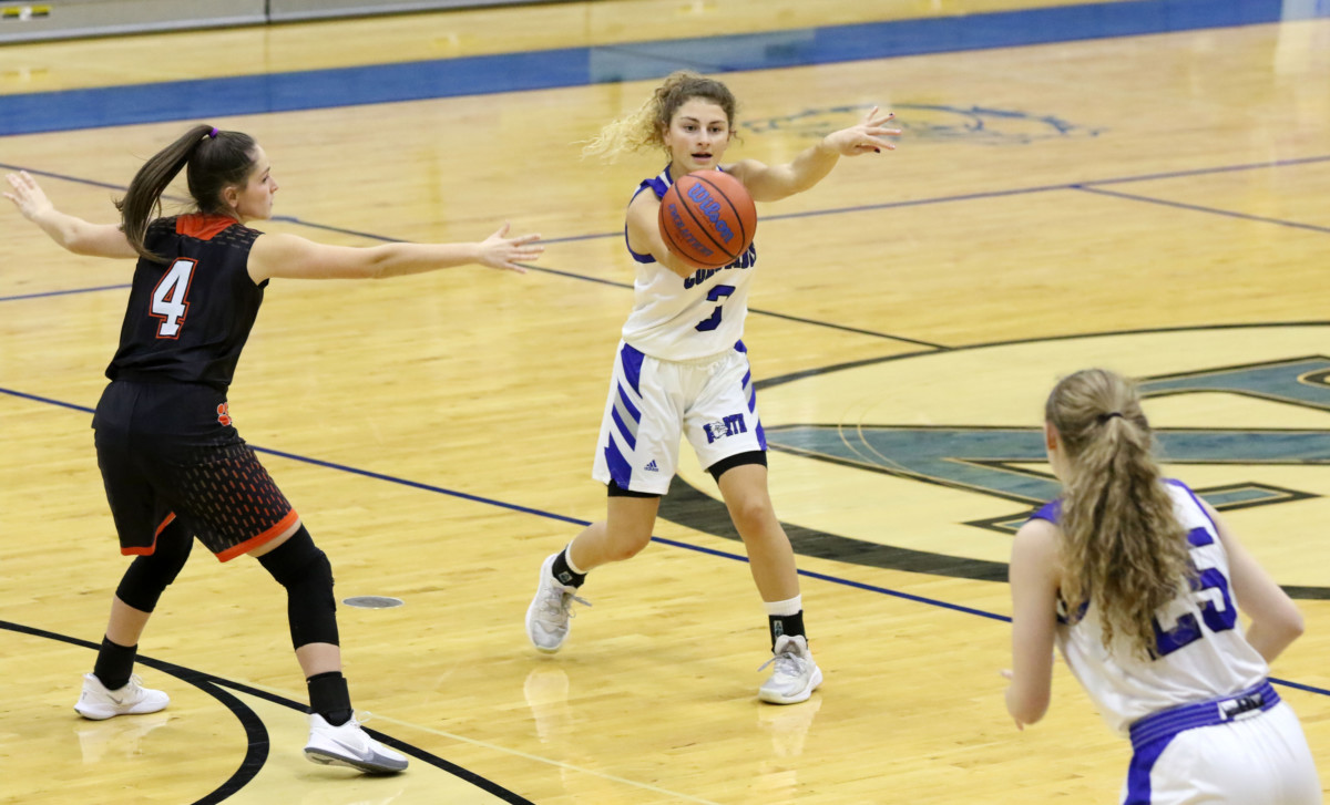 Columbus North's Lauren Barker passes the ball to Madison White while being guarded by LawrenceburgÕs Holly Knippenberg at Columbus North, Saturday, Jan. 16, 2021. Paige Grider for The Republic