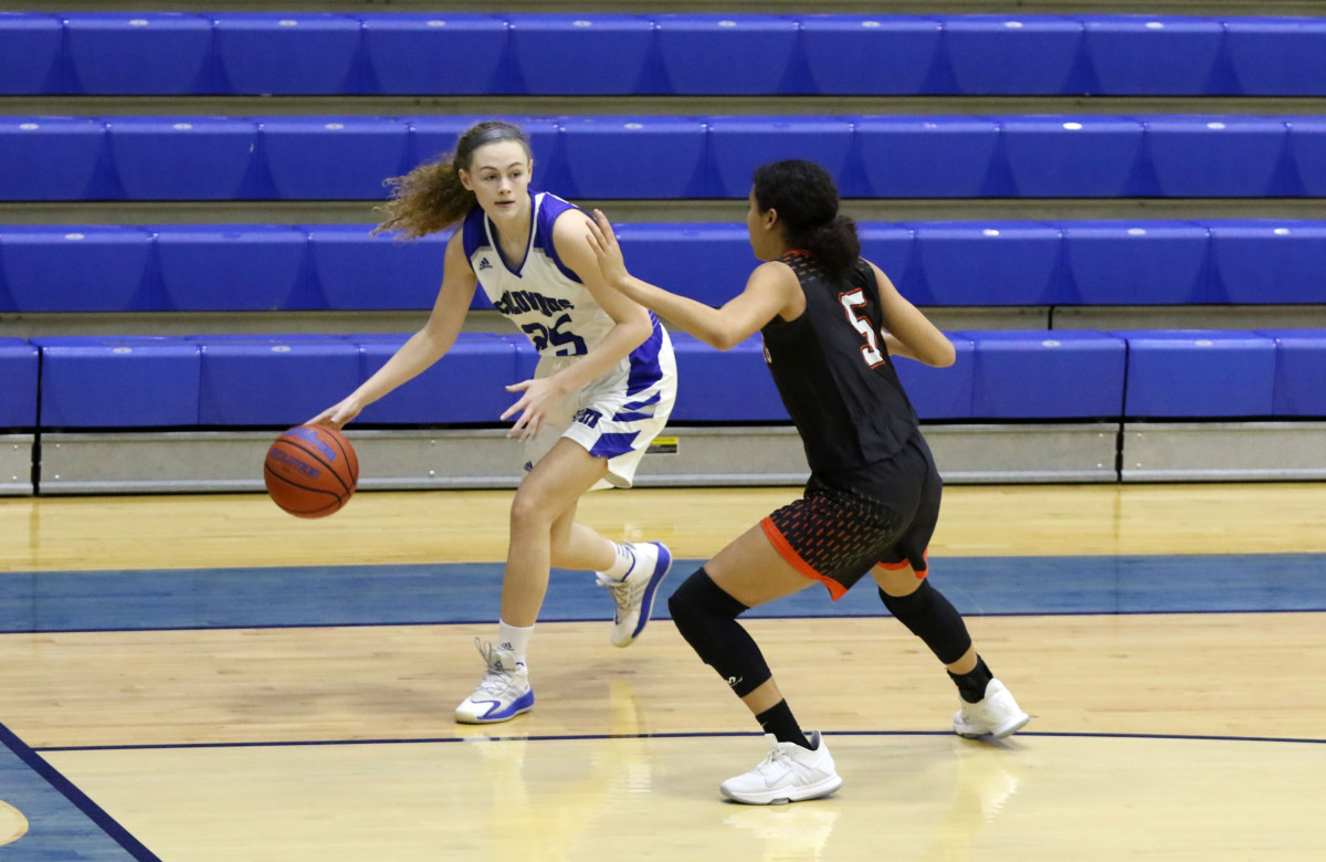 Columbus North's Madison White drives the ball in against Lawrenceburg's Kirsten Cross at Columbus North, Saturday, Jan. 16, 2021. Paige Grider for The Republic