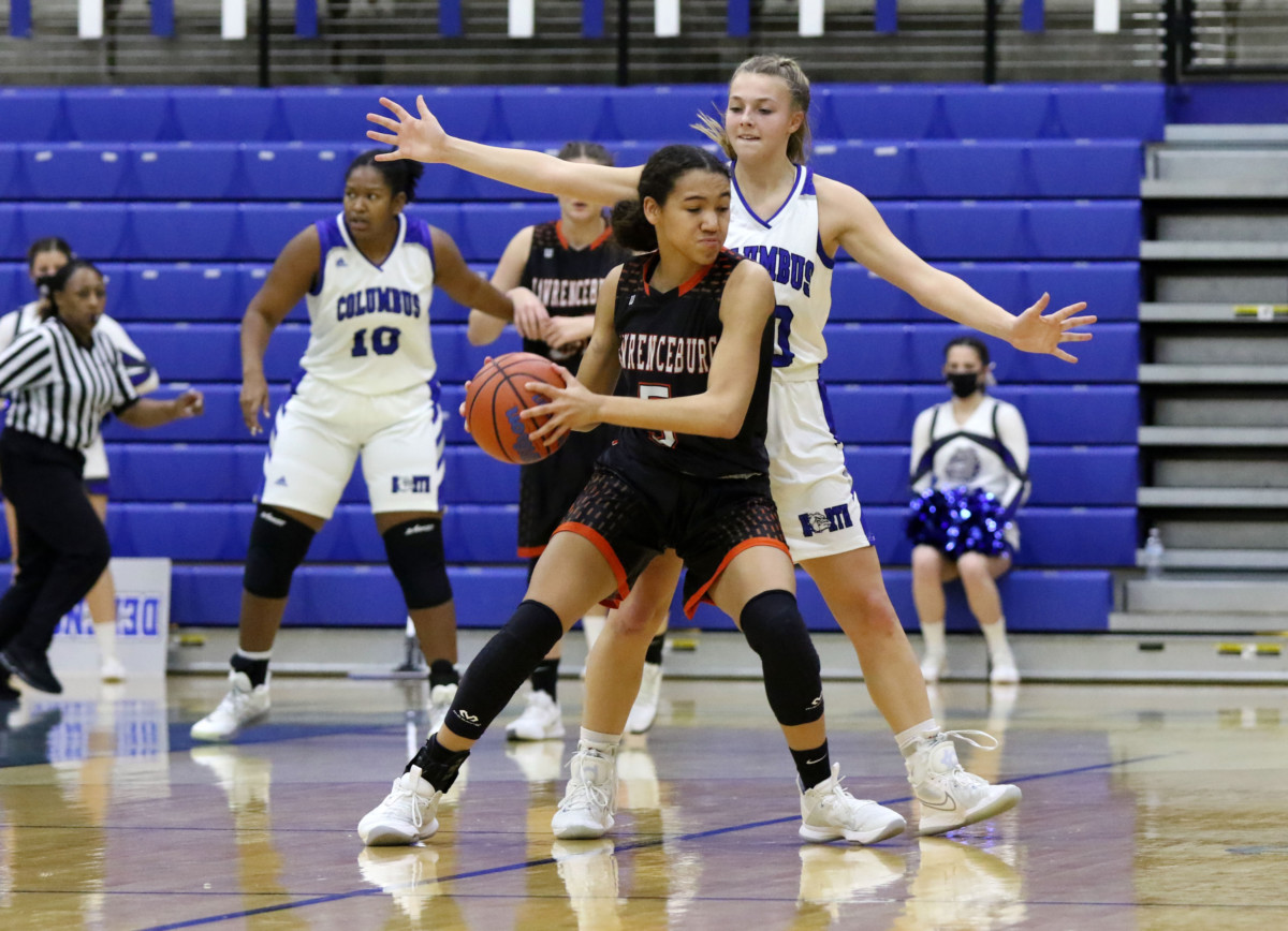 Columbus North's Alexa McKinley guards Lawrenceburg's Kirsten Cross at Columbus North, Saturday, Jan. 16, 2021. Paige Grider for The Republic