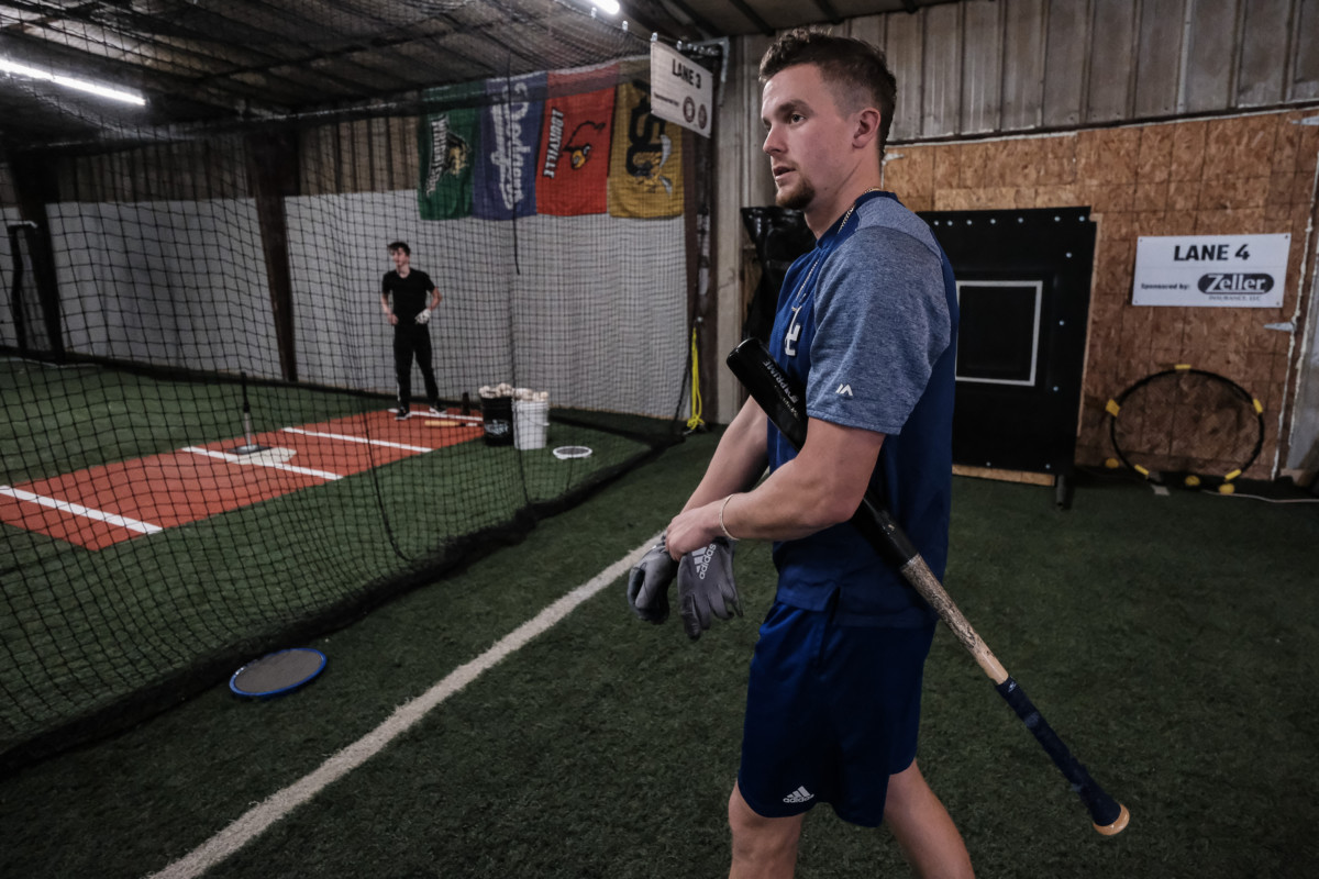Former Columbus North baseball player Devin Mann puts on his batting gloves before getting in some batting practice at HIT Baseball in Columbus, Ind., Friday, Jan. 22, 2021. He has been bouncing around the Dodgers' minor league system since being selected by the team in the fifth-round of the 2018 draft. Mike Wolanin | The Republic