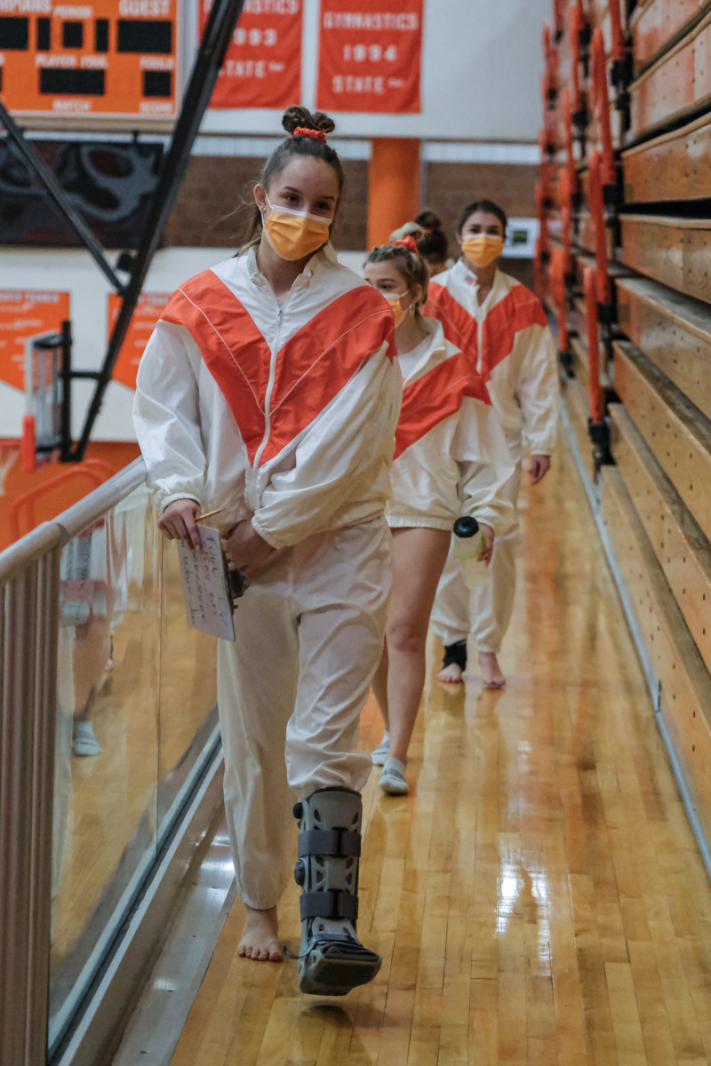 Columbus East's Reagan Mount is seen in a walking boot during a gymnastics meet between Columbus East and Franklin Central at Columbus East High School in Columbus, Ind., Tuesday Jan. 19, 2021. Mount Mount broke her foot during a meet against Columbus North in early January and just recently returned to action. Mike Wolanin | The Republic