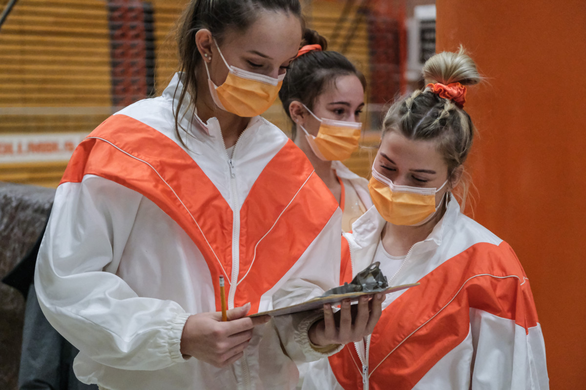 Columbus East's Reagan Mount, left, and Taylen Lane keep score during a gymnastics meet between Columbus East and Franklin Central at Columbus East High School in Columbus, Ind., Tuesday Jan. 19, 2021. Mount broke her foot during a meet against Columbus North in early January and just recently returned to action. Lane missed the entire regular season due to concussion like symptoms. Both gymnasts are expected to be healthy enough to compete in the sectional. Mike Wolanin | The Republic