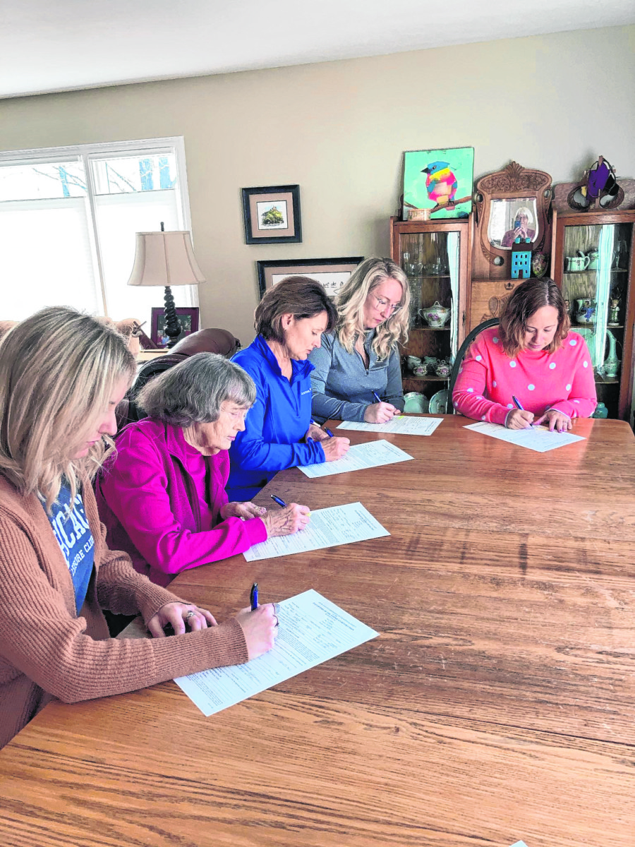 Members of the Glick family sign their DAR paperwork. From left are Rachael Forster, Donna Glick, Karen (Glick) Forster, Amy Forster and Lisa (Glick) Alderson.