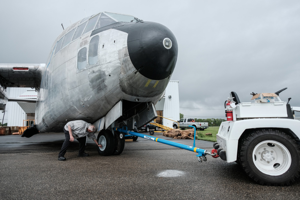 Bob Bolner checks the tire pressure on the front landing gear of a C-119 Boxcar before it’s towed to its display spot in front of the Atterbury-Bakalar Air Museum at the Columbus Municipal Airport in Columbus, Ind., Monday, May 17, 2021. Mike Wolanin | The Republic