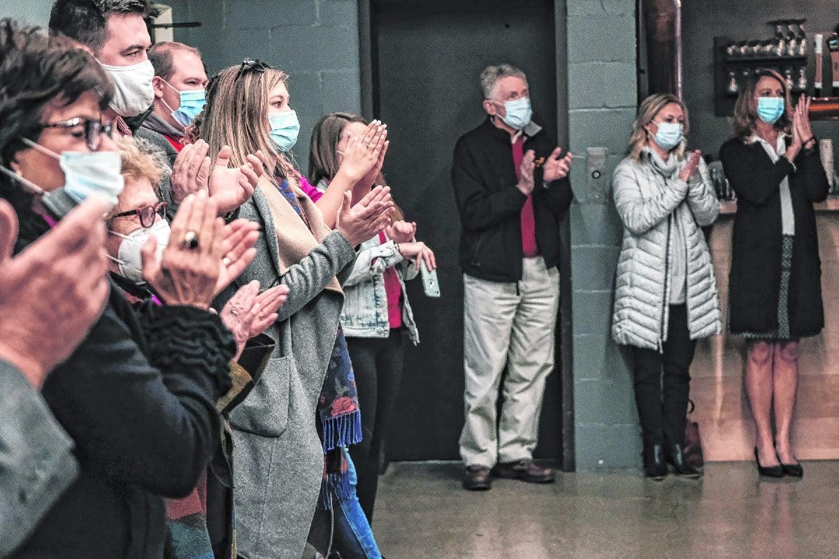 Supporters applaud during a campaign event for Gov. Eric Holcomb at the Upland Columbus Pump House in Columbus, Ind., Monday, Nov. 2, 2020. Gov. Holcomb and Lt. Gov. Suzanne Crouch visited with a group of supporters at the restaurant on their last campaign stop before election day. Mike Wolanin | The Republic