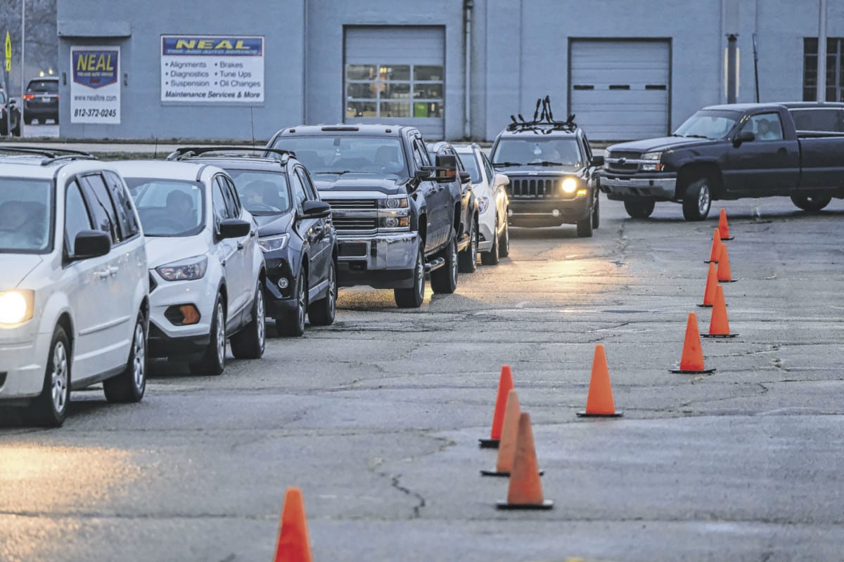 Vehicles line up to begin the delivery process for the Columbus Firemen's Cheer Fund. Photo by Mike Wolanin
