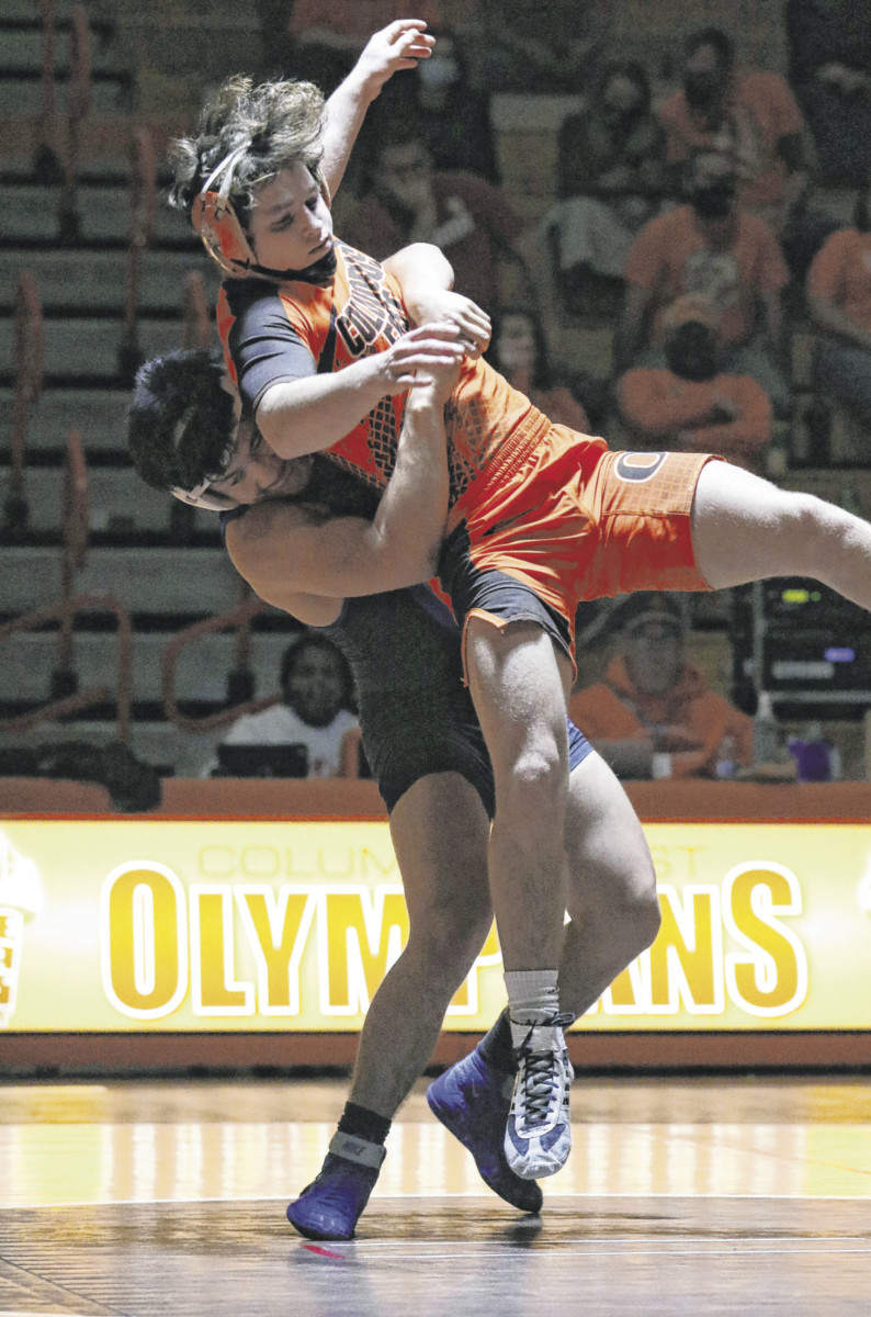 Columbus North’s Hector De Dios lifts Columbus East’s Kade Law in the 160-pound weight class at Columbus East, Thursday, Dec. 10, 2020. Paige Grider for The Republic