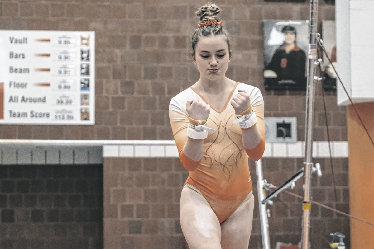 Columbus East’s Elise LaSell celebrates after completing her bars routine during a gymnastics meet between Columbus East and Owen Valley at Columbus East High School in Columbus, Ind., Monday, Feb. 22, 2021. Mike Wolanin | The Republic