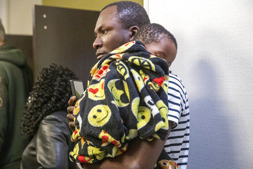 Family members await information about their loved ones who work at the FedEx facility in Indianapolis where a mass casualty shooting occurred late Thursday, on Friday, April 16, 2021. (The Indianapolis Star via AP)