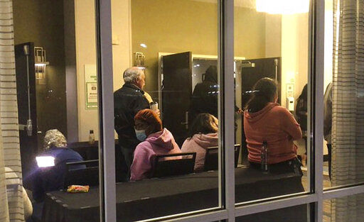 Family and friends at a nearby Holiday Inn Express wait for word of their loved ones who were at the FedEx Ground facility during a shooting in Indianapolis, Thursday night, April 15, 2021. Multiple people were shot and killed in a late-night shooting at a FedEx facility in Indianapolis, and the shooter killed himself, police said.(Mykal McEldowney/The Indianapolis Star via AP)