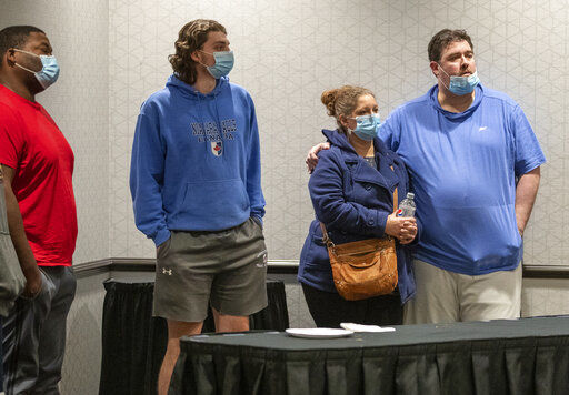Family members await information about their loved ones who work at the FedEx facility in Indianapolis where a mass casualty shooting occurred late Thursday, early Friday, April 16, 2021.(The Indianapolis Star via AP)