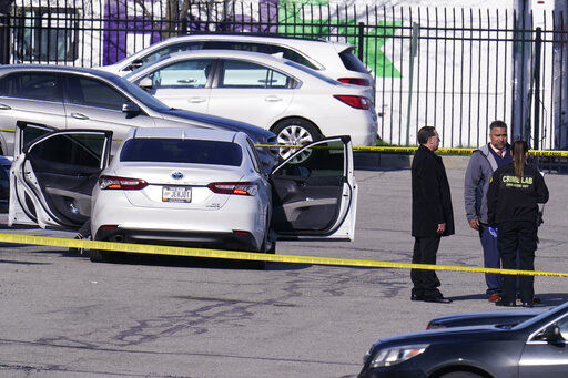 Authorities confer at the scene where multiple people were shot at the FedEx Ground facility early Friday morning, April 16, 2021, in Indianapolis. A gunman killed eight people and wounded several others before apparently taking his own life in a late-night attack at a FedEx facility near the Indianapolis airport, police said, in the latest in a spate of mass shootings in the United States after a relative lull during the pandemic. (AP Photo/Michael Conroy)