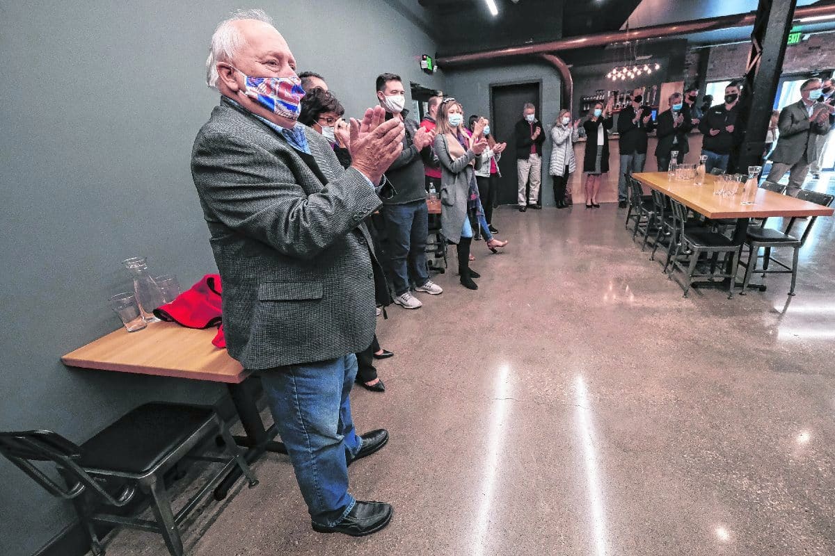 Tony Moravec and a room full of supporters applaud as Gov. Eric Holcomb is introduced during a campaign event at the Upland Columbus Pump House in Columbus, Ind., Monday, Nov. 2, 2020. Gov. Holcomb and Lt. Gov. Suzanne Crouch visited with a group of supporters at the restaurant on their last campaign stop before election day. Mike Wolanin | The Republic