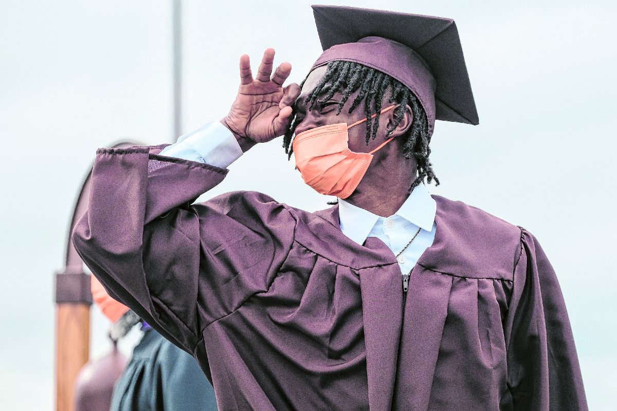 Tyrell Bowers raises his hand to eye as he looks at his classmates after receiving his diploma during the commencement ceremony for Columbus East’s Class of 2021 at Columbus East High School in Columbus, Ind., Saturday, May 29, 2021. Mike Wolanin | The Republic
