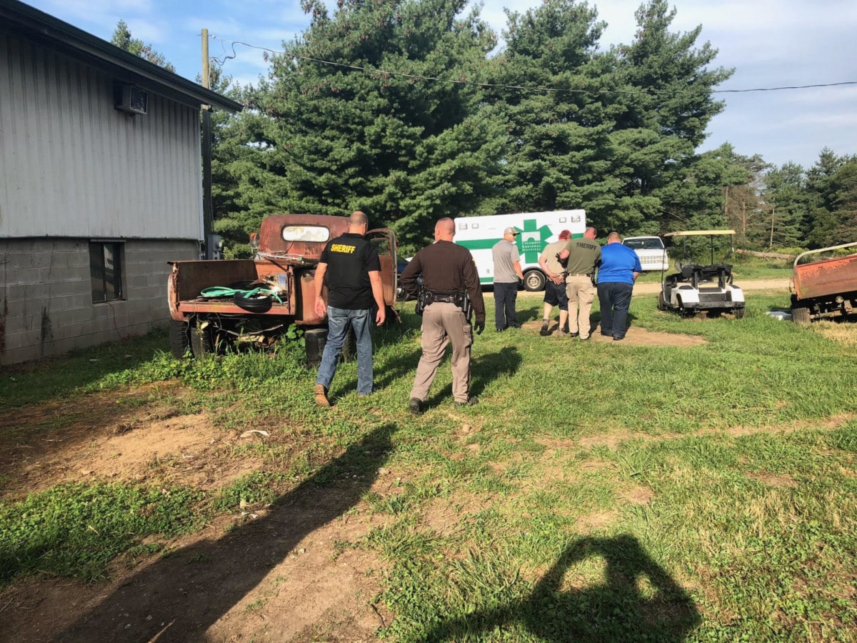 Bartholomew County Sheriff deputies take suspect into custody at his father's barn, where he was found in an attic.