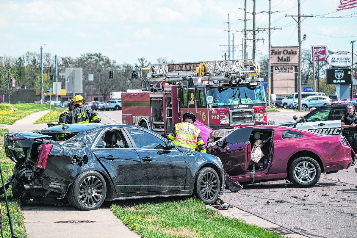 Columbus police and firefighters work the scene of an accident after a high speed chase that ended in a crash on National Road in Columbus, Ind., Friday, April 9, 2021. Mike Wolanin | The Republic  Mike Wolanin | The Republic