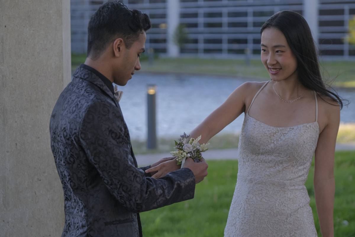 Columbus North student Rishi Rao, left, and North student Tiffany Fu do the time honored tradition of putting on the corsage as they pose for prom photos at the Cummins Corporate Office Building in Columbus, Ind., Saturday, May 1, 2021. Mike Wolanin | The Republic