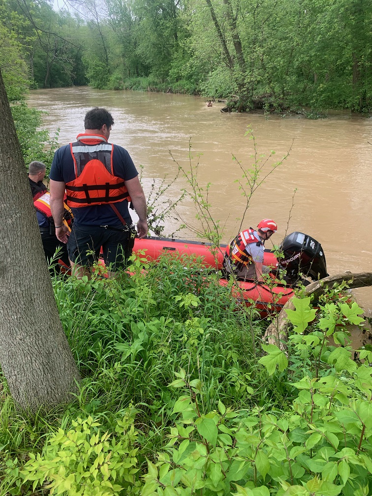 Water rescue team members prepare to launch to rescue teen waiting in the creek. Photo provided