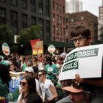 Tens of thousands march to kick off climate summit, demanding end to warming-causing fossil fuels