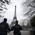A French investigating judge hands terror-linked charges to a man accused of killing tourist