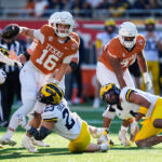 Manning uses arm and legs to lead No. 14 Texas to a 41-27 Citrus Bowl win over No. 18 Michigan
