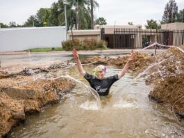 A South African politician goes snorkeling in a giant pothole to highlight city management failures